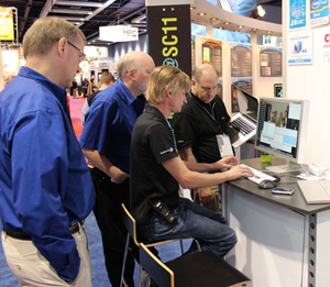 Goddard network engineers (in blue) Paul Lang (left) and Bill Fink (right) work with collaborators on high-speed data transfer demo at SC11.